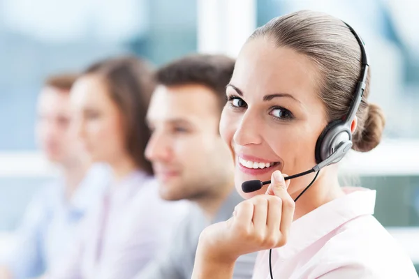 Customer support professional wearing a headset at a modern contact centre